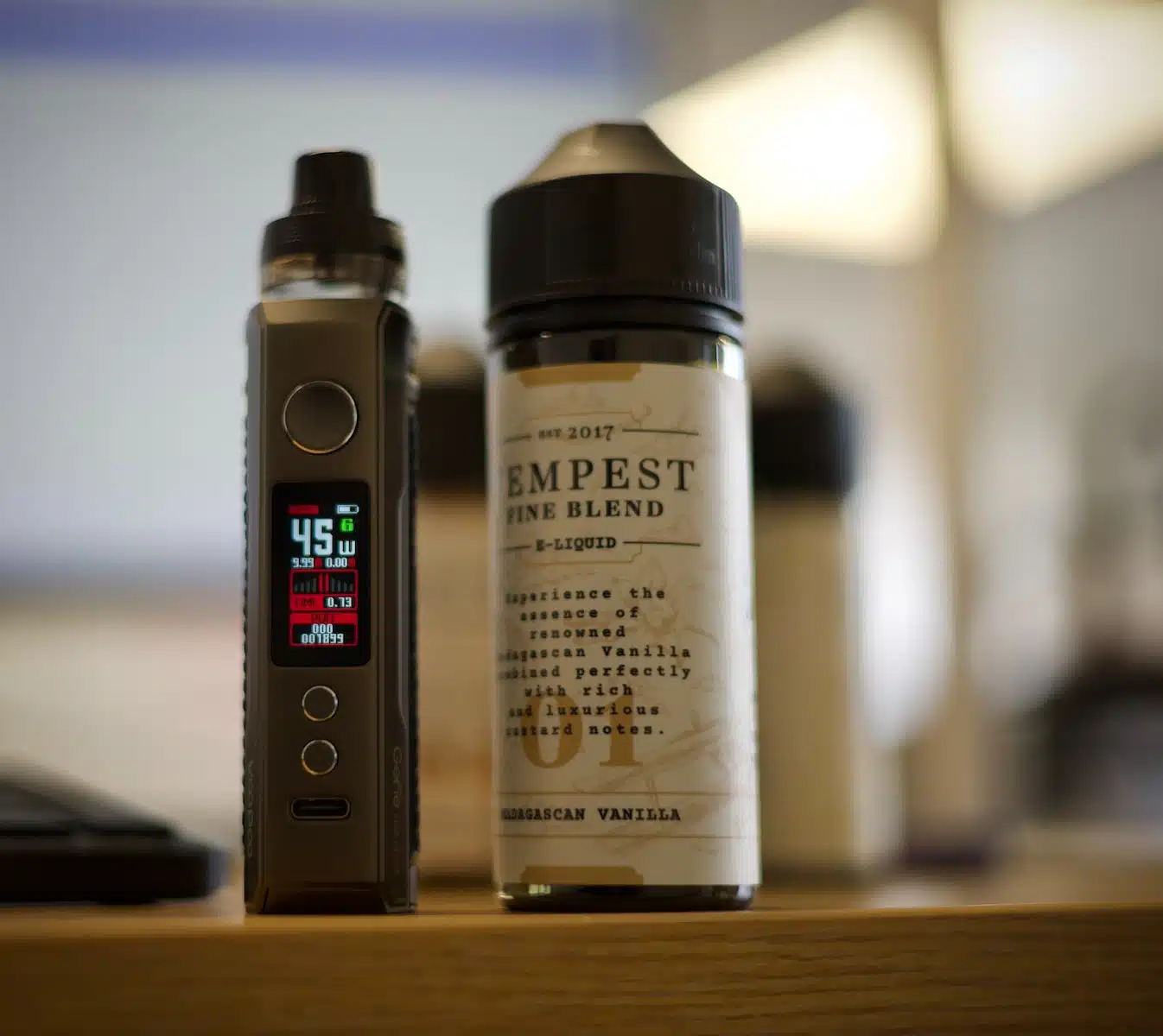 an electronic device sitting next to a bottle of liquid